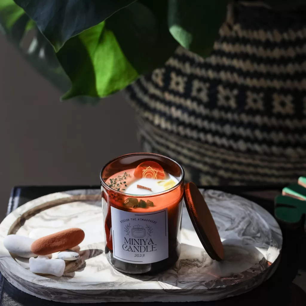 A cozy candle with a decorative lid, perfect for setting a warm indoor ambiance.